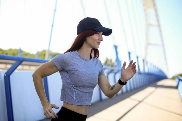 istock Woman running on bridge 1161384141