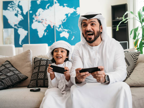 istock Arab dad and son playing with video games at home 1161386349