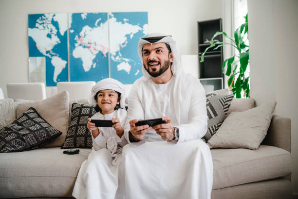 istock Arab dad and son playing with video games at home 1161386351