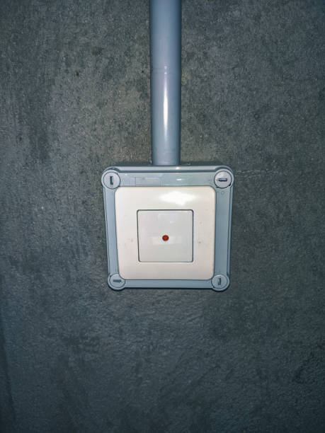 istock anti-theft pushbutton with light grey surface on cement wall in garage 1161386684