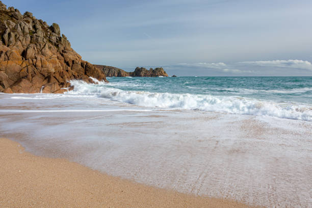 Waves crashing on the beach at Porthcurno Cornwall England UK Europe