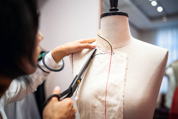 istock Tailor cutting cloth to make a dress 1161389022