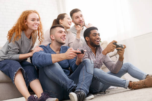 istock Students playing video games online at home 1161390656