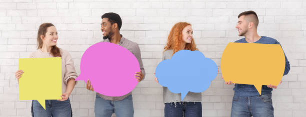 istock Friends holding thoughtful bubbles over white wall 1161390882