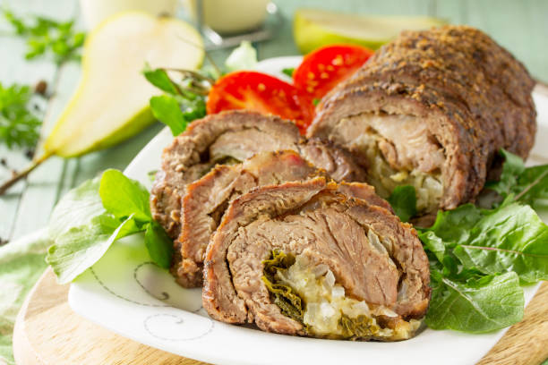 istock Stuffed Meat close-up Roll with Pear and Cheese on a festive Thanksgiving Day table. 1161391123