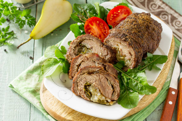 istock Stuffed Meat Roll with Pear and Cheese on a festive Thanksgiving Day table. 1161391130