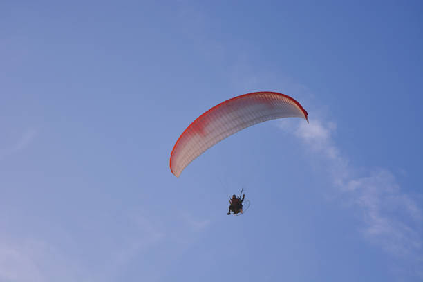 istock Paramotor (Powered Paraglider) With Red-White Parachute Flying In Sky, Extreme Sport. 1161392318