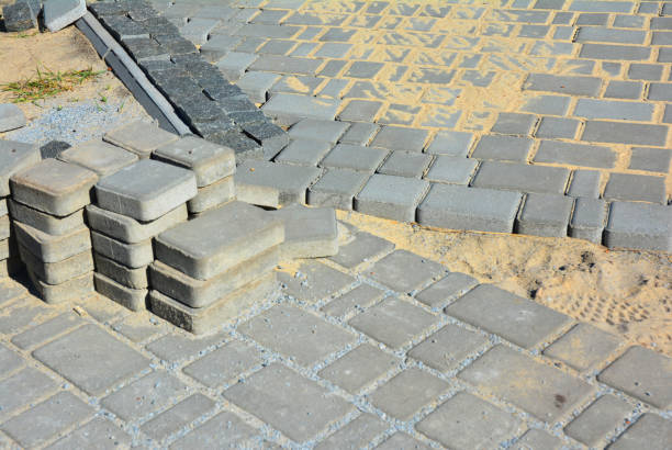 istock Pavestone paver installation. Pavement road construction. 1161394825