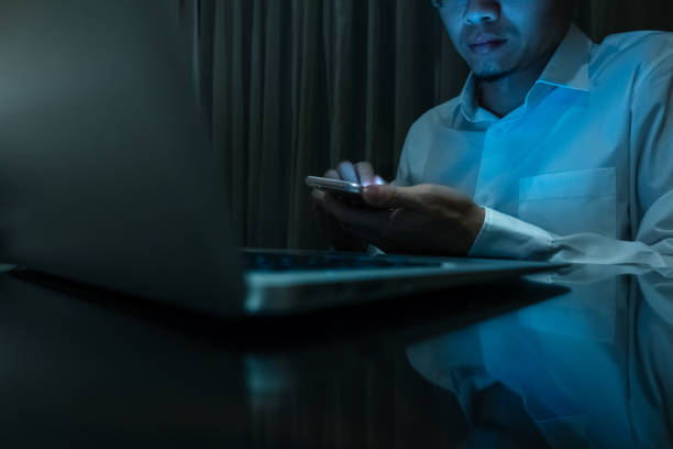 istock Businessman touching mobile phone at night 1161399566