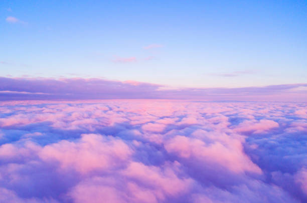 Aerial view White clouds in blue sky. Top view. View from drone. Aerial bird's eye view. Aerial top view cloudscape. Texture of clouds. View from above. Sunrise or sunset over clouds Aerial view White clouds in blue sky. Top view. View from drone. Aerial bird's eye view. Aerial top view cloudscape. Texture of clouds. View from above. Sunrise or sunset over clouds stratosphere airplane cloudscape mountain stock pictures, royalty-free photos & images