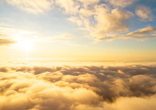 istock Aerial view White clouds in blue sky. Top view. View from drone. Aerial bird's eye view. Aerial top view cloudscape. Texture of clouds. View from above. Sunrise or sunset over clouds 1161401310