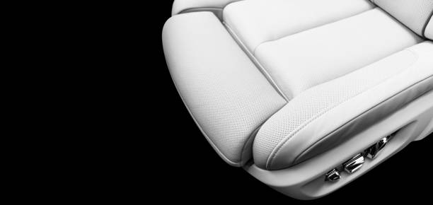 istock White leather interior of the luxury modern car. Perforated white leather comfortable seats with stitching isolated on black background. Modern car interior details. Car detailing. Car inside 1161402390