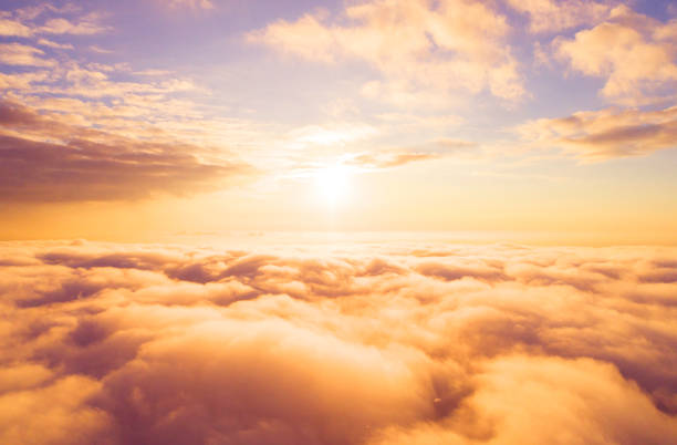 Aerial view White clouds in blue sky. Top view. View from drone. Aerial bird's eye view. Aerial top view cloudscape. Texture of clouds. View from above. Sunrise or sunset over clouds Aerial view White clouds in blue sky. Top view. View from drone. Aerial bird's eye view. Aerial top view cloudscape. Texture of clouds. View from above. Sunrise or sunset over clouds stratosphere airplane cloudscape mountain stock pictures, royalty-free photos & images