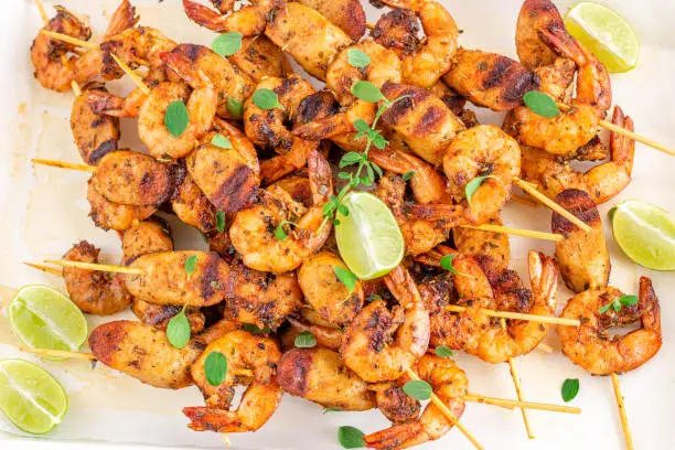 Grilled Shrimp Kebab on Skewers Horizontal Photo. Shrimp / Prawn Roasted Garnished with Oregano and Lemon.