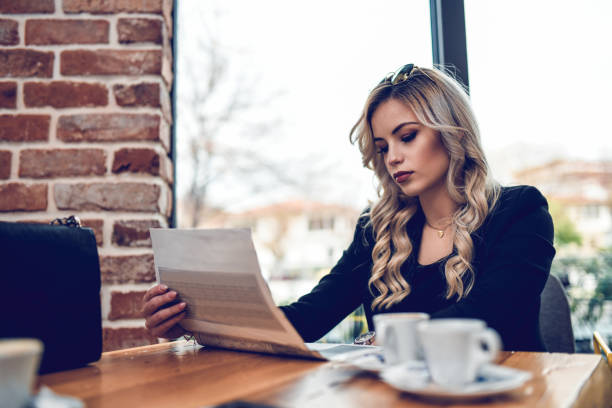 istock Cute Female Enjoying Coffee And Newspaper 1161404705