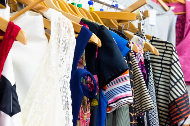 Clothes on a Rack in Second Hand Store UK, Arts Culture and Entertainment, Bazaar Market, Charitable Donation, Charitable Foundation clothing swap photos stock pictures, royalty-free photos & images