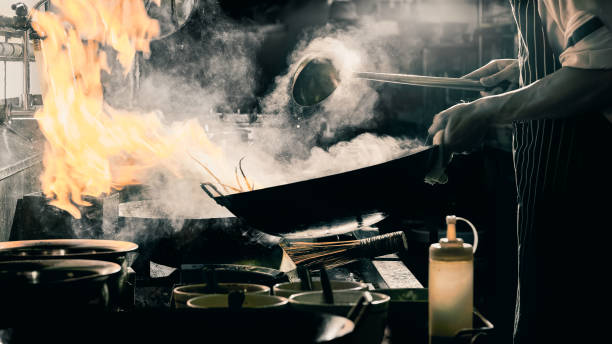 istock Chef stir fry in wok 1161405246