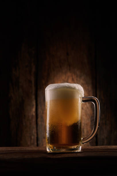 istock Beer in mug on wooden table 1161405261