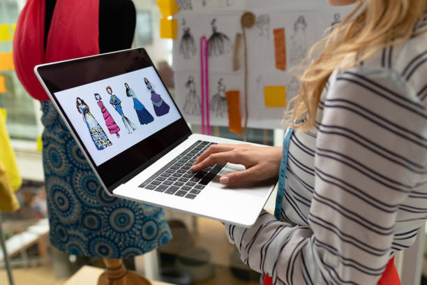 istock Female fashion designer using laptop in design studio 1161405273
