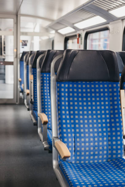 istock Rows of blue fabric seats inside empty modern train, travel concept, selective focus. 1161407724