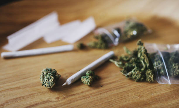Made by man and mother nature Shot of dried marijuana and a rolled joint marijuana stock pictures, royalty-free photos & images