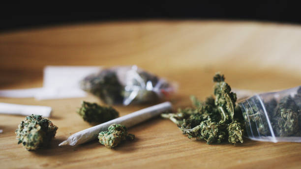 Weed and all of it's paraphernalia Shot of dried marijuana and a rolled joint blunts stock pictures, royalty-free photos & images