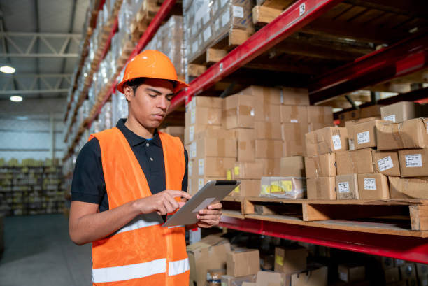 istock Young man looking focused at the inventory on digital tablt at a warehouse 1161410950