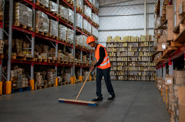 istock Manual worker cleaning floors at a distribution warehouse 1161410976
