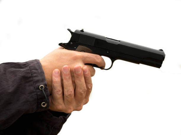 istock Killer holding a gun, Hand holding guns isolated on white background. 1161412059