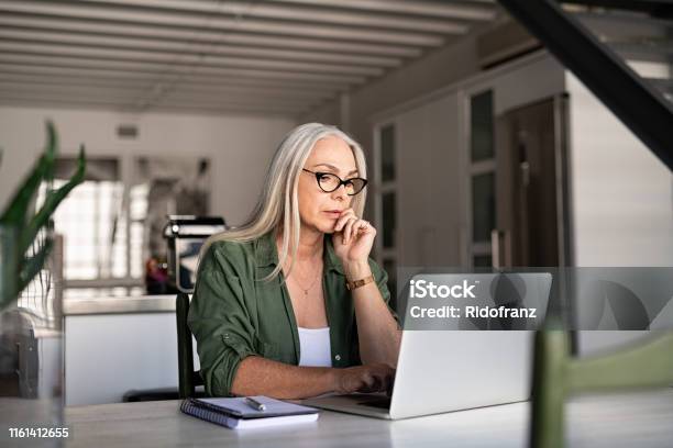 Worried Senior Woman Using Laptop Stock Photo - Download Image Now - Laptop, Women, One Woman Only