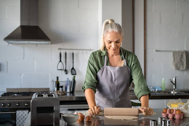 istock Senior woman rolling cookie dough at home 1161412870