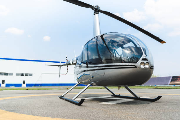 istock helicopter with propeller on concrete Helipad during daytime 1161414200