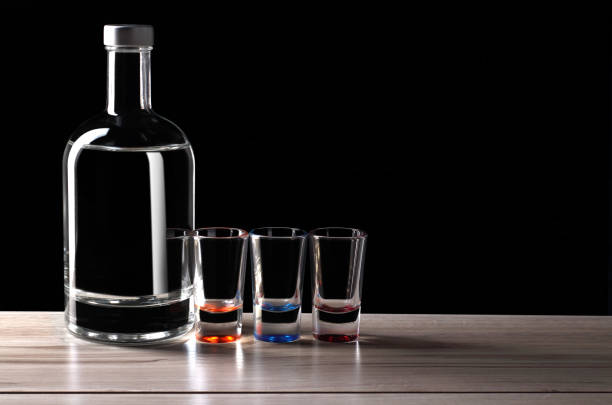 istock bottle of vodka with glasses 1161414857