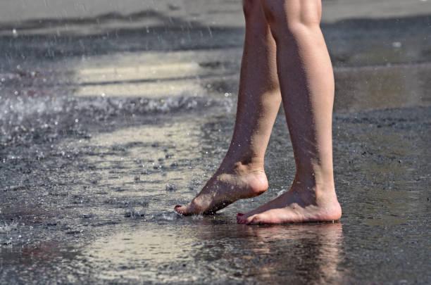 istock Walk barefoot in the rain through the puddles. 1161415149