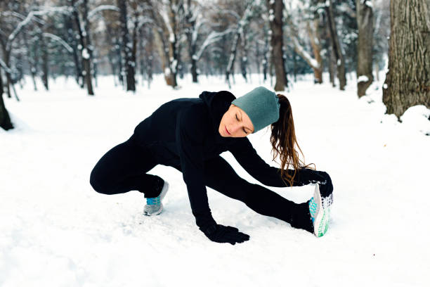 istock Female athlete exercising in park in winter 1161415635