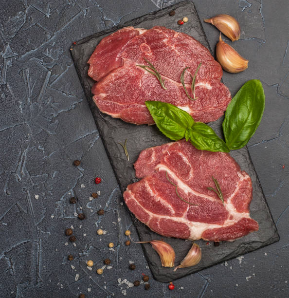 istock Raw fresh meat with spices and rosemary. 1161415682