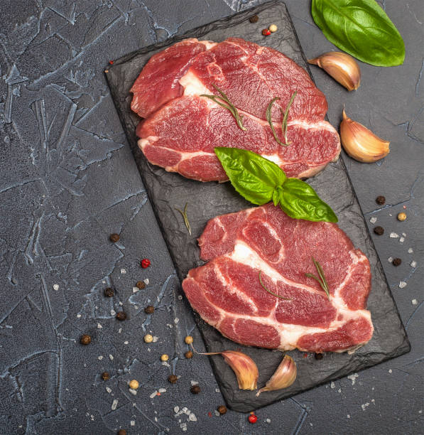 istock Raw fresh meat with spices and rosemary. 1161415683