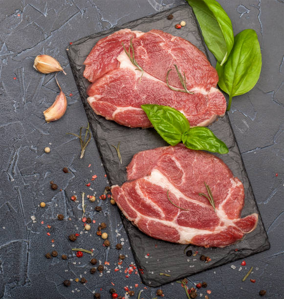 istock Raw fresh meat with spices and rosemary. 1161415718