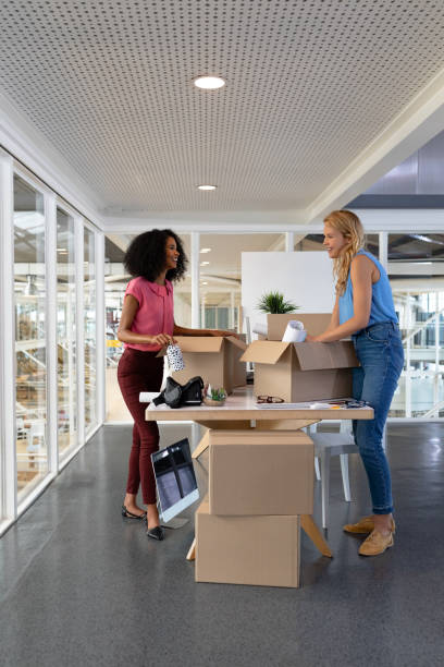 istock Female executives unpacking cardboard boxes in office 1161416239