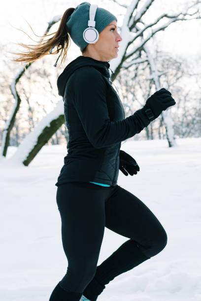 istock Female athlete jogging in park in winter 1161416863