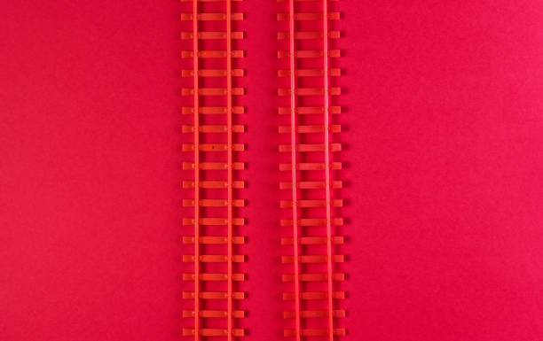 istock Toy railway rails on a red background. Top view 1161419642