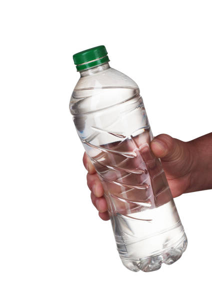 istock a bottle of water held in a hand 1161419984