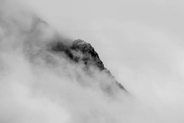 istock a mountain peak with a lot of fog 1161420006