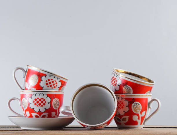 istock Many antique ceramic cups on a wooden table against a white wall 1161421179