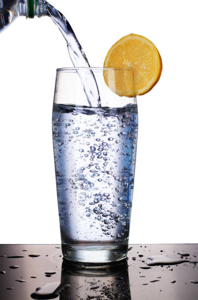istock pouring water into a glass of lemon 1161421238