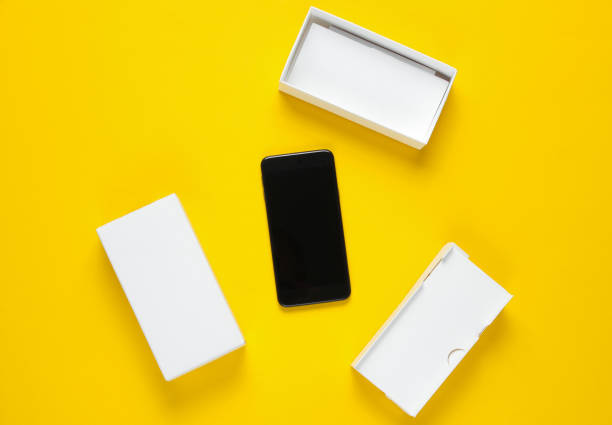 istock New smartphone with box on yellow background. Minimalism concept, unboxing 1161421501