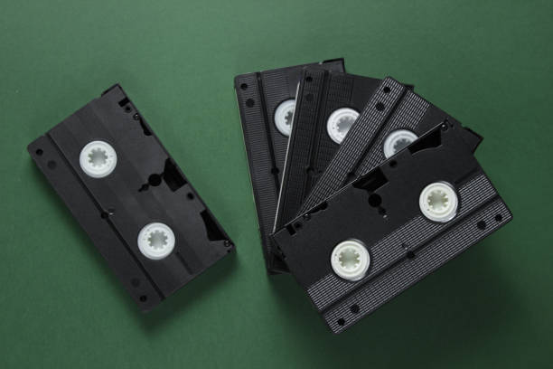 istock Stack of retro video cassettes on green background. Top view 1161421639