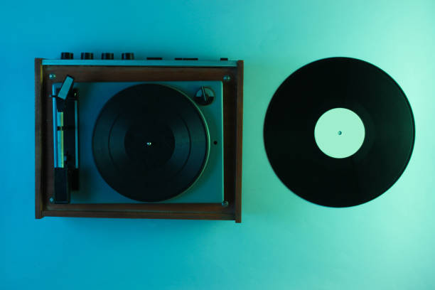 istock Retro vinyl record player with vinyl plates. Neon light, top view 1161421884