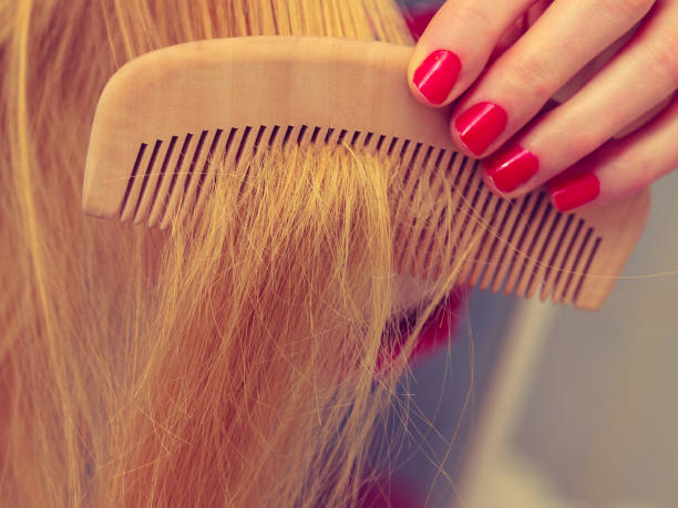 istock Female hand holding comb closeup 1161421920