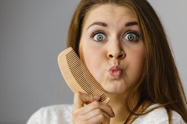 istock Happy woman brushing her hair 1161422749